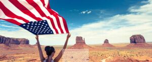 woman holding american flag in desert